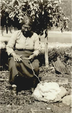 Tlingit woman hand-spinning mountain goat wool.