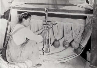 Tlingit woman weaving a Chilkat Blanket.